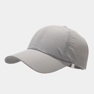 Detailed view of breathable laser-cut vents on dark grey quick-dry performance baseball cap