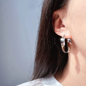 Irregular twisted geometric hoop earrings in polished silver metal for women