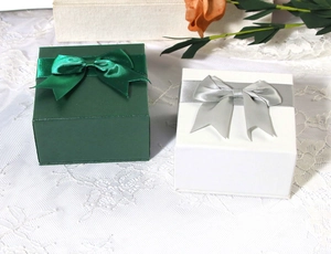 Square jewelry gift box in dark green and white with elegant decorative ribbon bow