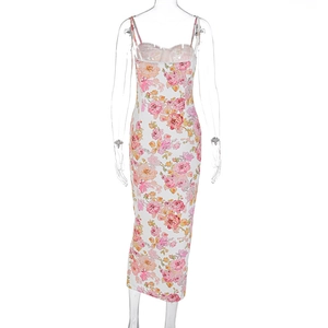 Gros plan de l'imprimé floral rose et jaune sur une robe camisole blanche ajustée