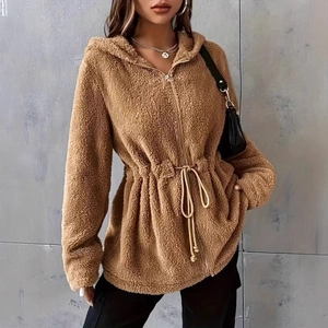 Macro detail of brown teddy fleece hoodie featuring adjustable drawstring waist and zipper