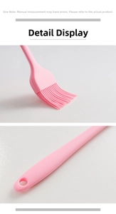 Detailed view of pink silicone oil brush with flexible bristles and hanging hole handle