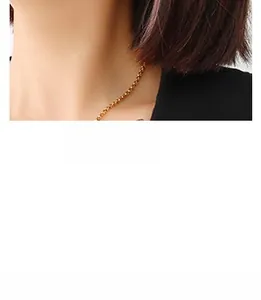 Close-up of a delicate 18K gold plated stainless steel chain necklace on a model neck