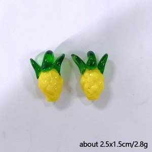 Detail view of yellow glass pineapple pendant with green leaves including size and weight