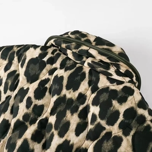 Detailed close-up of quilted leopard print jacket neckline showing seam stitching and texture