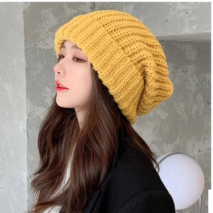 Detail of yellow chunky knit beanie showing thick texture and folded cuff for winter warmth