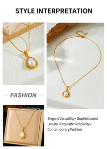 Detailed view of golden teardrop pendant necklace with white pearl on white background