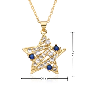 Detail of 24mm gold star pendant with micro-pave white crystals and blue accent gems