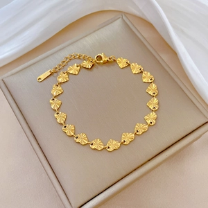 Close-up of gold titanium steel heart link bracelet with adjustable extension chain