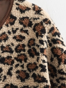 Vue détaillée du tissu pelucheux à motif léopard et des coutures du col