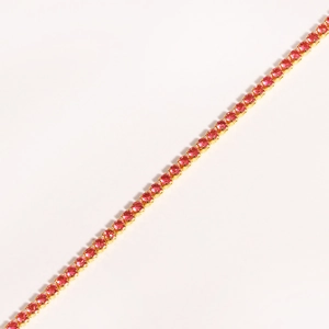Detail of single row gold-plated tennis bracelet featuring round pink zircon stones