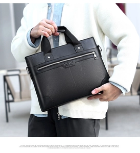 Close-up of black lychee grain leather texture and brand logo on business briefcase