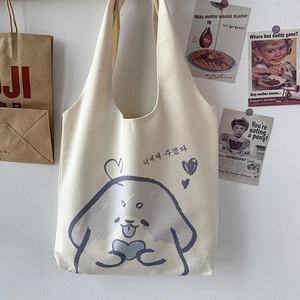 Detail of off-white canvas tote bag featuring cute cartoon dog and Korean lettering