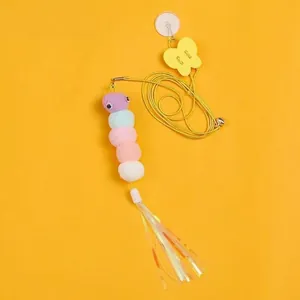 Macro shot of colorful plush caterpillar cat teaser with bell and elastic string