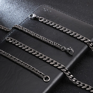 Close-up of retro black stainless steel curb chains in various thicknesses on leather