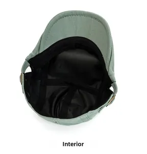 Detail of cotton newsboy cap with black satin lining and bronze side buckles