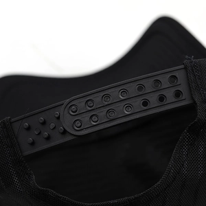 Detail of adjustable snapback closure on black mesh trucker hat with durable plastic strap