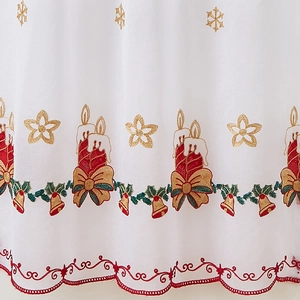 Detailed embroidery of Christmas candles and green holly on a white lace door curtain