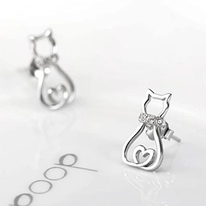 Fashionable silver hollow cat earrings with zircon stones and a heart motif