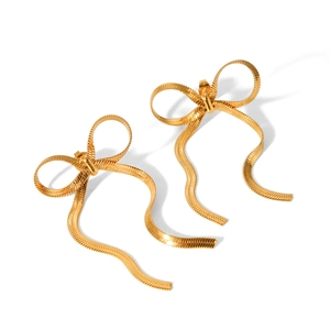 Detail of 18k gold plated snake chain texture on stylish metallic bow-shaped stud earrings