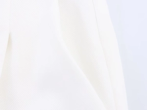 Macro shot of high-quality white linen blend fabric texture with sharp diagonal twill weave
