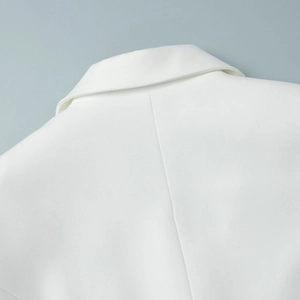 Detailed close-up of white lace blazer shoulder with premium twill fabric texture