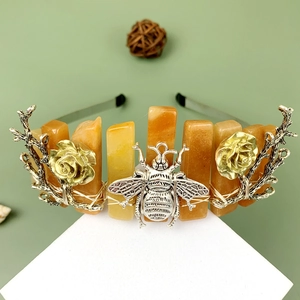 Silver crown headband with metal bees, roses, and orange natural stone beads on a stand