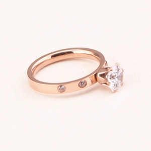 Classic rose gold six-prong solitaire ring with side stone accents on white background
