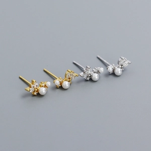 Macro detail of elegant flower pearl earrings with sparkling marquise zircon accents