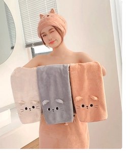 Close-up of coral fleece hair towels featuring cute 3D cartoon cat ear designs