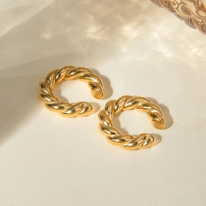 Minimalist 18k gold stainless steel twisted rope hoop earrings on beige background