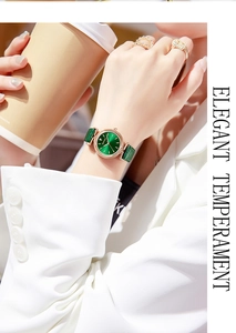 Elegant lady wearing a green leather quartz watch with gold case in a cafe setting
