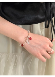 Detail of beaded strawberry bracelet with glass beads and silver extension chain