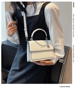 Close-up of white PU leather square bag featuring silver chain and FASHION & BAGS logo