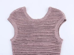 Detailed close-up of mauve hollow out knitted short sleeve top with woven texture