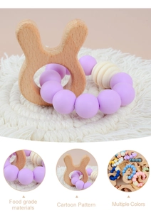 Detail of baby teething bracelet featuring a beech wood bunny and purple silicone beads