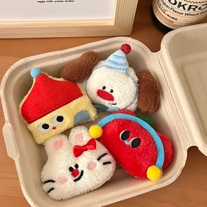 Macro shot of cute plush cartoon charms including a white bunny and blue puppy