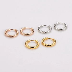 Three pairs of geometric stainless steel hoop earrings in rose gold, silver, and gold colors