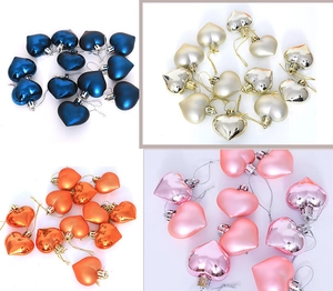Collage of 5cm heart Christmas ornaments in blue, gold, silver, orange and pink tones
