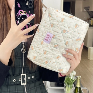 Floral quilted cotton makeup bag in cream with vintage orange flower pattern