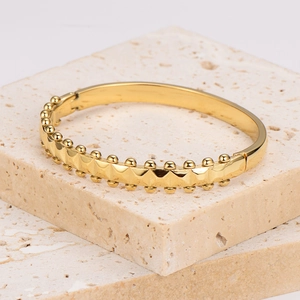 Retro stainless steel wave bracelet with gold rivets and bead design on stone