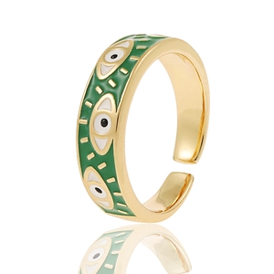 Detail of gold open ring featuring green enamel and multiple evil eye patterns