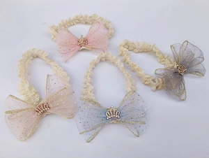 Set of four lace baby headbands with glittery mesh bows and tiny golden crowns