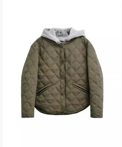 Detail of olive green quilted jacket with diamond texture and contrast grey hood lining