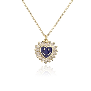 Detail of gold heart pendant with blue enamel smiley face and zircon crystals