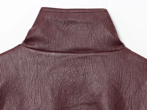 Macro shot of wine red vintage PU leather jacket featuring stand collar and cracked texture