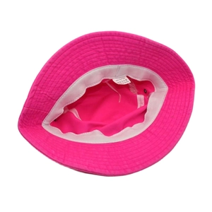 Detail of fuchsia cotton bucket hat interior showing breathable eyelets and material label
