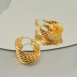 French vintage style gold braided hoop earrings with metallic luster on mirror base