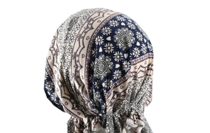 Detail view of ethnic navy and beige daisy print turban hat with stretch fabric texture