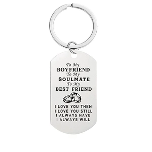 Detail of silver stainless steel dog tag keychain with engraved romantic quote for boyfriend